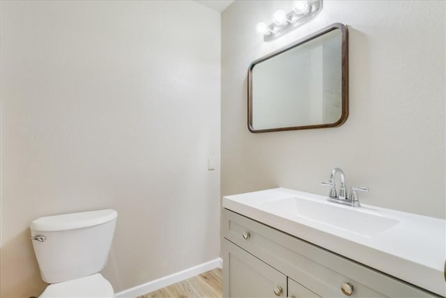 4113 Sierra St, Corpus Christi, TX 78410 - half bath featuring vanity, toilet, baseboards, and wood finished floors