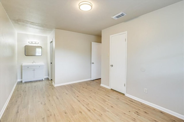 4113 Sierra St, Corpus Christi, TX 78410 - unfurnished bedroom featuring light wood finished floors, baseboards, and ensuite bath
