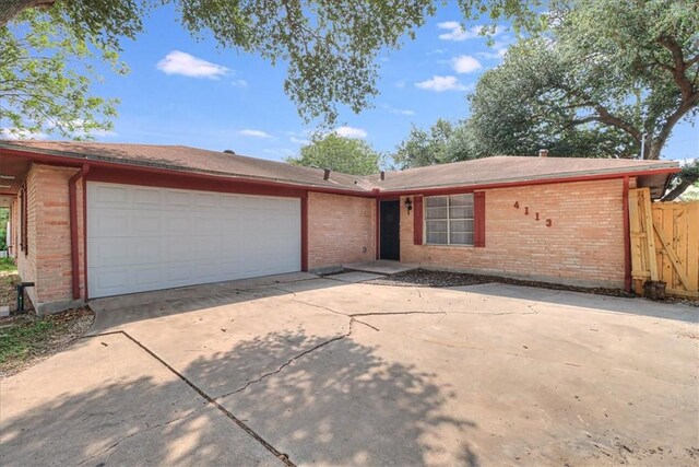 4113 Sierra St, Corpus Christi, TX 78410 - ranch-style home featuring brick siding, a garage, and driveway