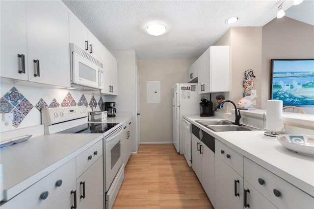 kitchen featuring white cabinetry, sink, white appliances, a textured ceiling, and light hardwood / wood-style flooring