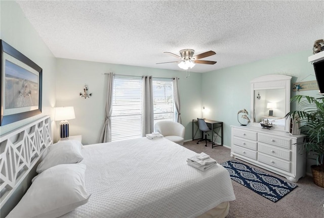 carpeted bedroom with a textured ceiling and ceiling fan