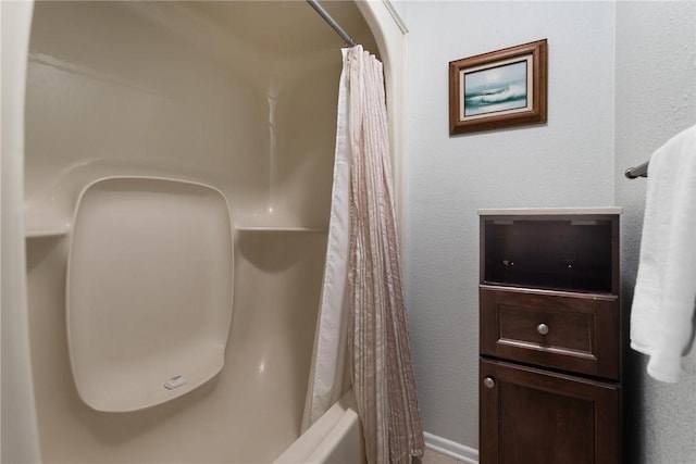 bathroom with shower / bath combination with curtain