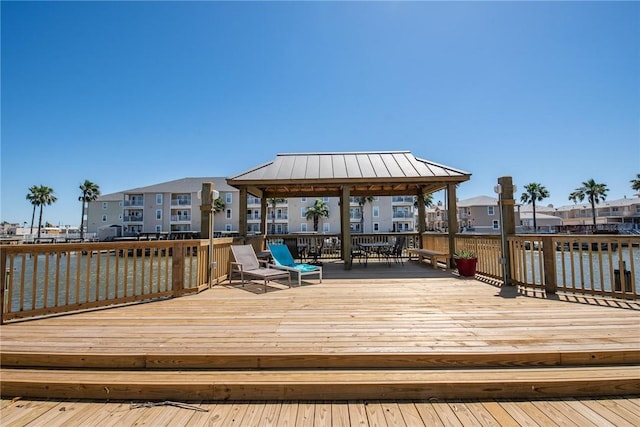 wooden terrace with a water view and a gazebo