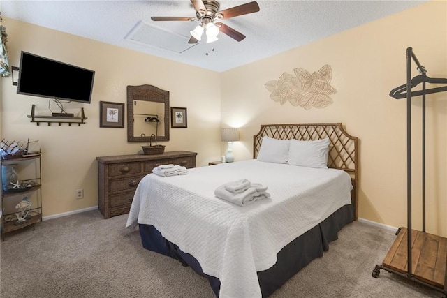 bedroom with a textured ceiling, light colored carpet, and ceiling fan