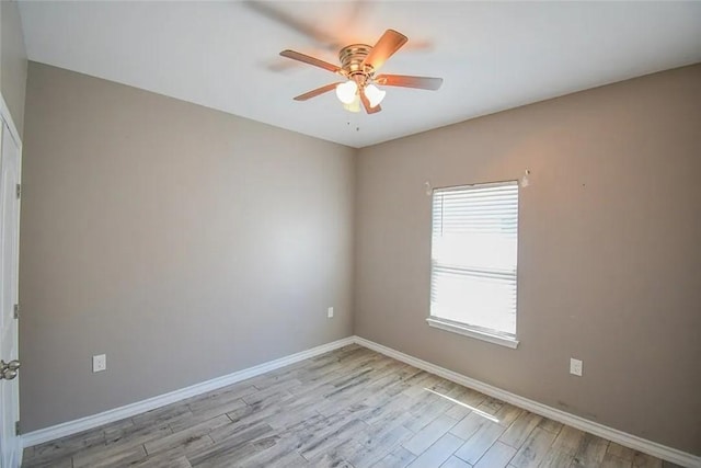 1325 S Mccampbell St, Aransas Pass, TX 78336 - spare room with light wood-type flooring, a ceiling fan, and baseboards