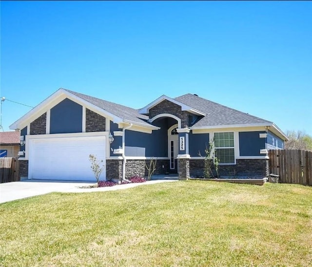 1325 S Mccampbell St, Aransas Pass, TX 78336 - view of front of home featuring stone siding, an attached garage, concrete driveway, and roof with shingles