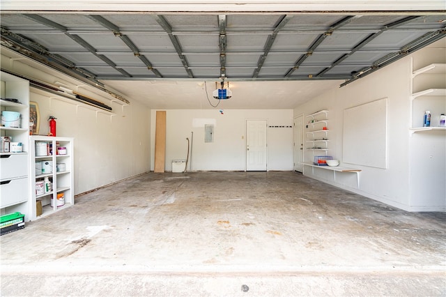 garage featuring electric panel and a garage door opener