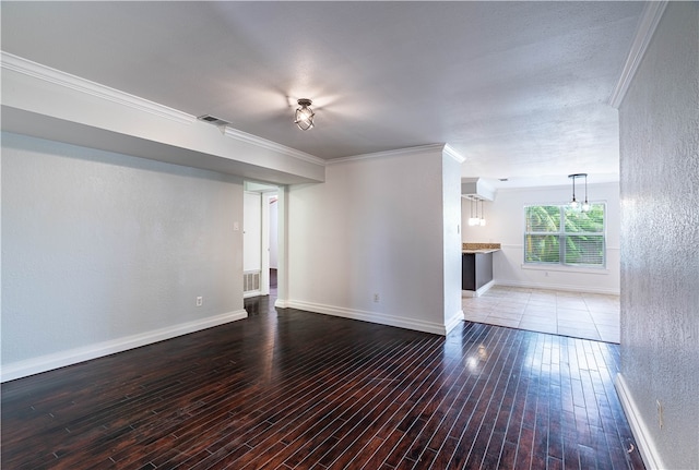 unfurnished living room with wood-type flooring and ornamental molding