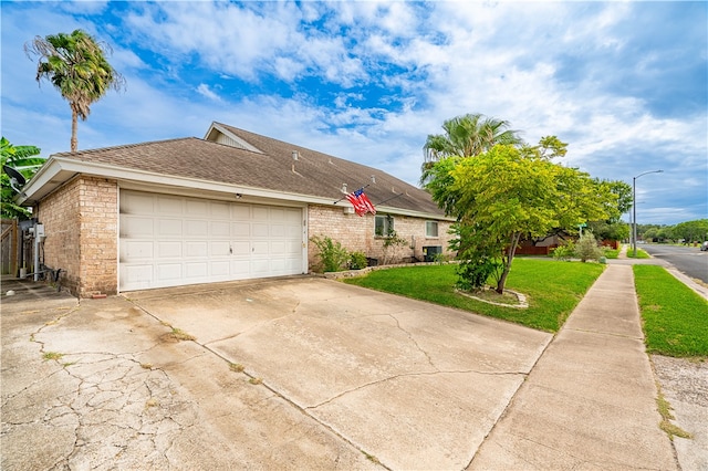 ranch-style house featuring a garage and a front yard