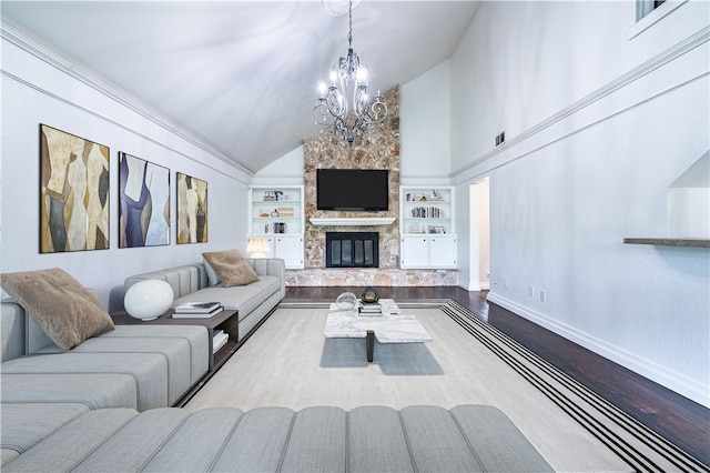 living room with wood-type flooring, built in features, a chandelier, a stone fireplace, and lofted ceiling