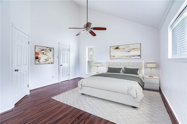 bedroom with multiple windows, ceiling fan, high vaulted ceiling, and dark hardwood / wood-style floors