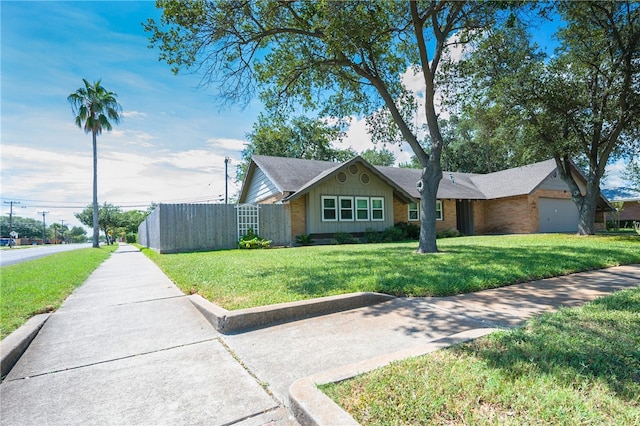 single story home with a garage and a front lawn