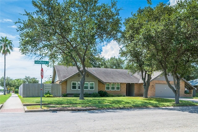 ranch-style house with a front yard and a garage