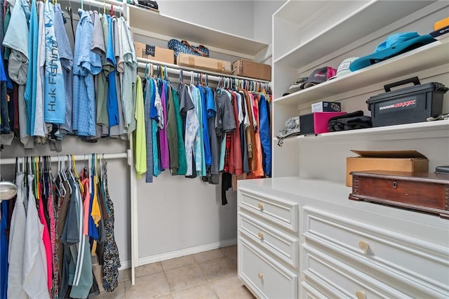 spacious closet with light tile patterned floors