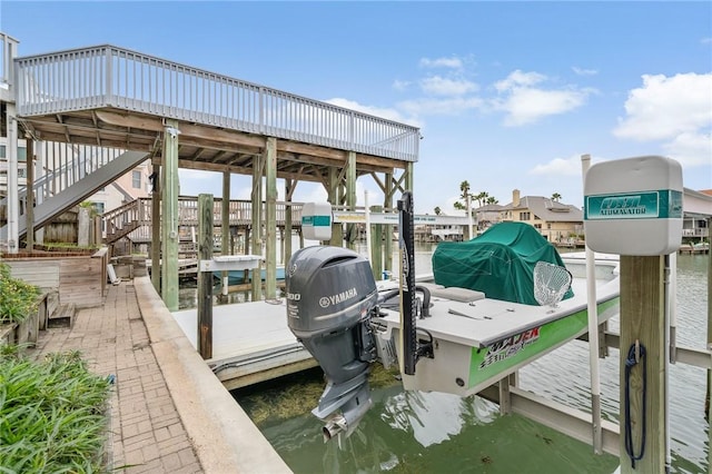 view of dock featuring stairs, a water view, and boat lift