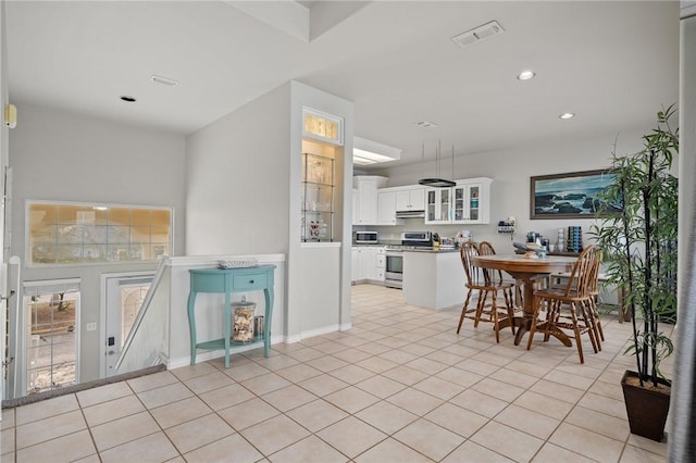 dining space featuring light tile patterned floors, visible vents, and recessed lighting