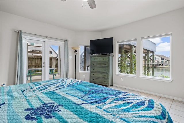 bedroom featuring ceiling fan, light tile patterned flooring, baseboards, access to outside, and french doors