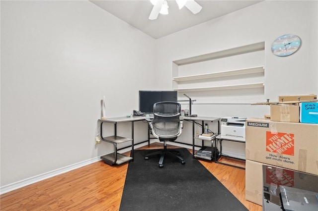 office featuring light wood finished floors, ceiling fan, and baseboards