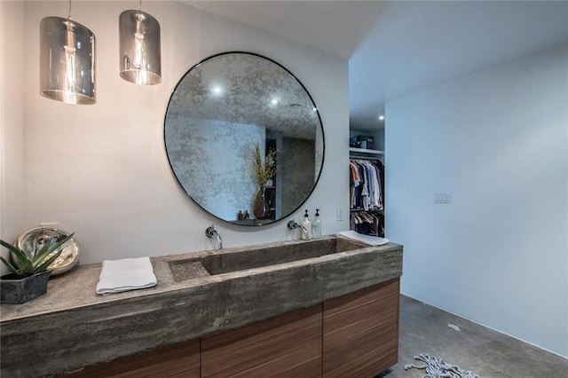 901 N Upper Broadway St Unit 206, Corpus Christi, TX 78401 - bathroom featuring vanity, concrete floors, and a spacious closet