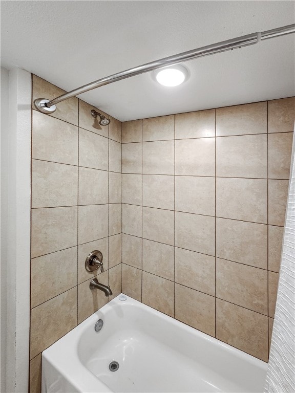 bathroom with shower / bath combo with shower curtain