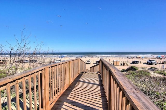 view of property's community with a beach view and a water view