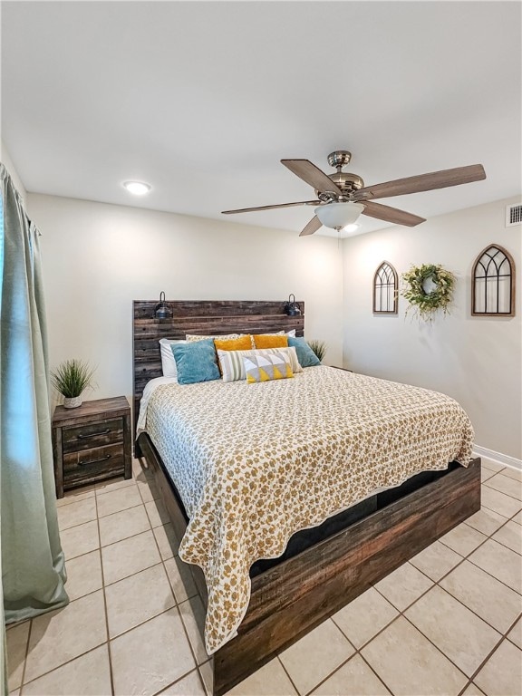 bedroom with ceiling fan and light tile patterned floors