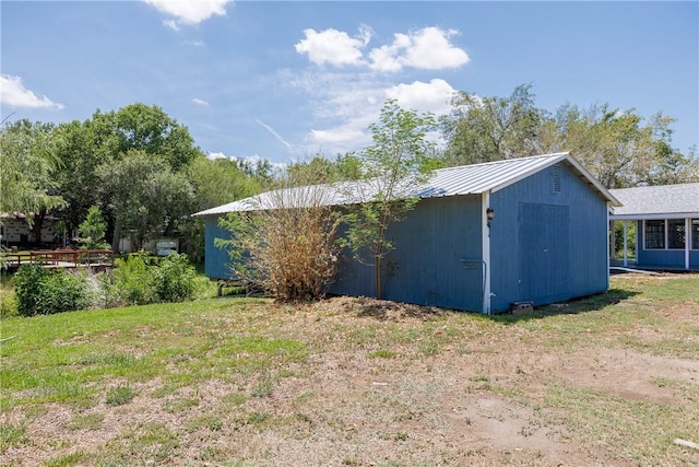 view of outdoor structure with a lawn