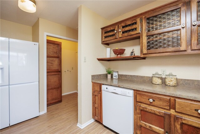 kitchen with white appliances and light wood-type flooring