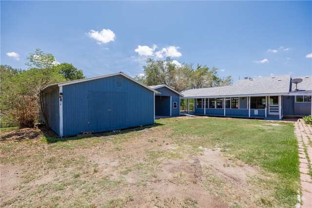 back of house with a lawn