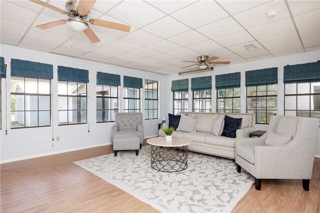 sunroom featuring a paneled ceiling and ceiling fan