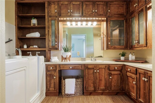 bathroom featuring wood-type flooring, washer / dryer, and vanity