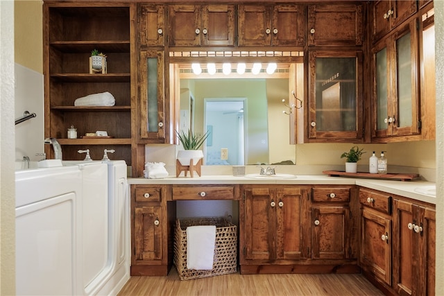 bathroom featuring vanity, hardwood / wood-style flooring, and washer / dryer