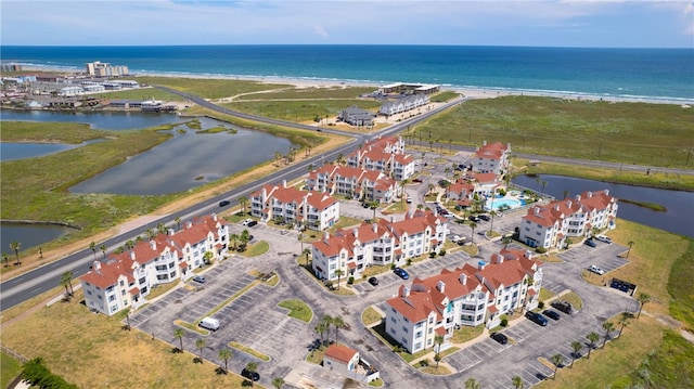 drone / aerial view featuring a water view and a view of the beach