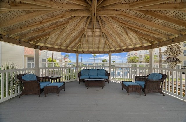 sunroom / solarium with lofted ceiling with beams, plenty of natural light, and wood ceiling