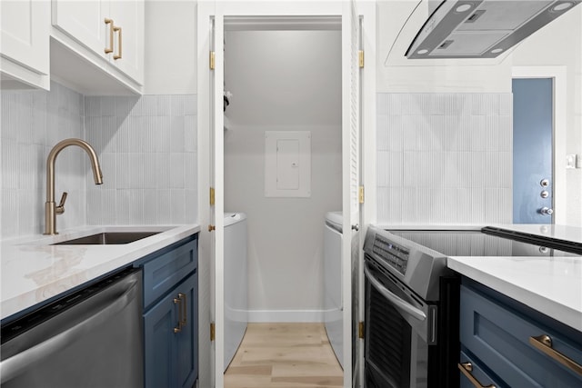 kitchen featuring blue cabinetry, sink, light hardwood / wood-style floors, white cabinets, and appliances with stainless steel finishes