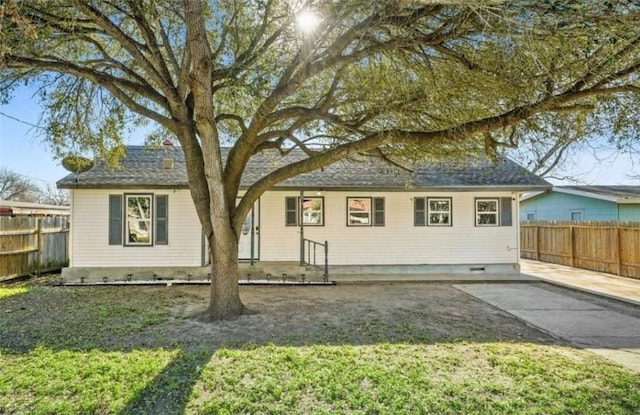 rear view of property with a yard and a patio