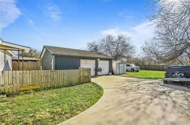 view of side of home with a garage, a lawn, and an outdoor structure