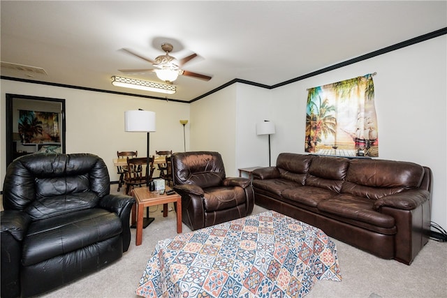 carpeted living room featuring ornamental molding and ceiling fan