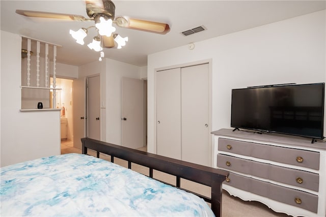 bedroom featuring light carpet, ceiling fan, and a closet