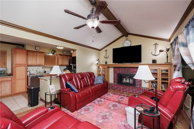 tiled living room featuring ornamental molding, lofted ceiling with beams, a fireplace, and ceiling fan