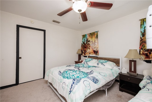 bedroom with ceiling fan and light carpet