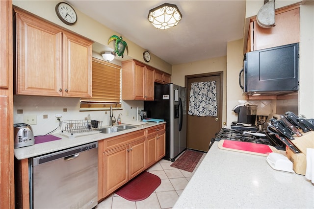 kitchen with decorative backsplash, stainless steel appliances, sink, and light tile patterned floors