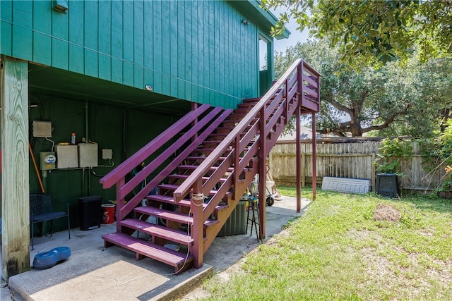 view of playground featuring a lawn and a patio