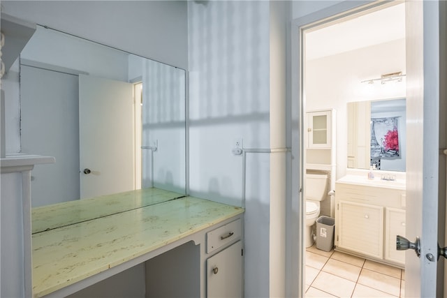 bathroom featuring vanity, tile patterned floors, and toilet