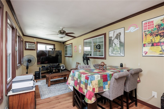 dining space featuring ornamental molding, a wall mounted AC, ceiling fan, and light hardwood / wood-style flooring