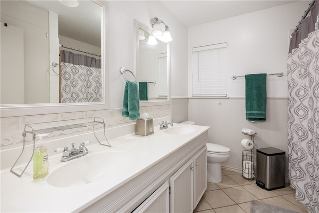 bathroom featuring toilet, vanity, and tile patterned floors