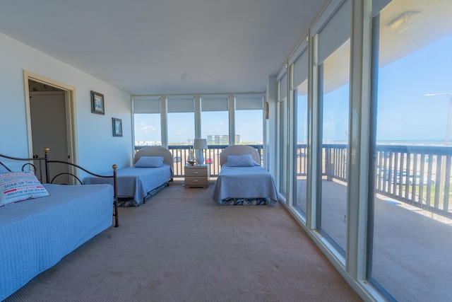 sunroom featuring a water view