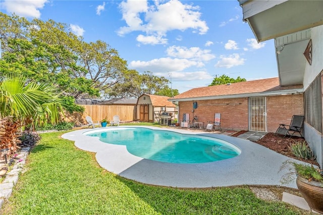 view of swimming pool featuring a patio, a yard, a fenced backyard, and a fenced in pool