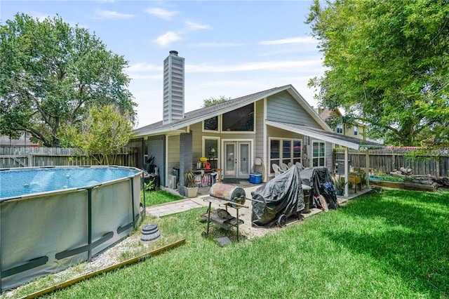 6906 Whalen Dr, Corpus Christi, TX 78413 - back of house with french doors, a chimney, and a fenced backyard