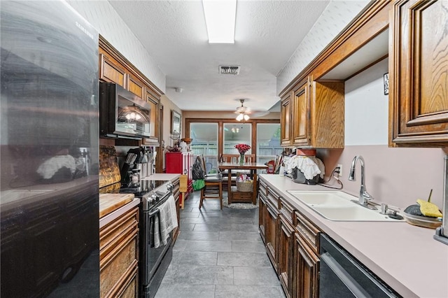 6906 Whalen Dr, Corpus Christi, TX 78413 - kitchen featuring stainless steel microwave, range with electric stovetop, freestanding refrigerator, dishwasher, and light countertops